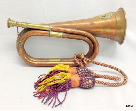 A copper military bugle with a Western Australian University reg crest of arms