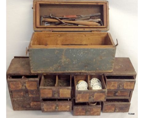 A watchmakers cabinet with tools and watch parts