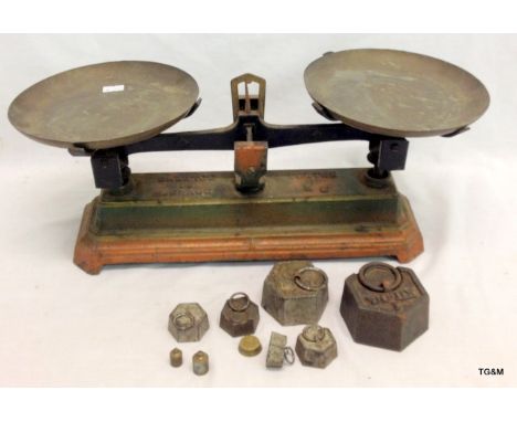 A set of vintage cast iron weighing scales with weights