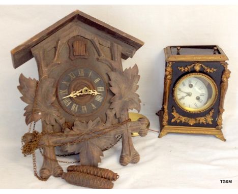 A wall cuckoo clock and a mantle clock