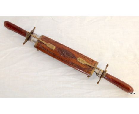 An engraved wooden handled Indian Carving knife and fork in a table standard scabbard 44cm long