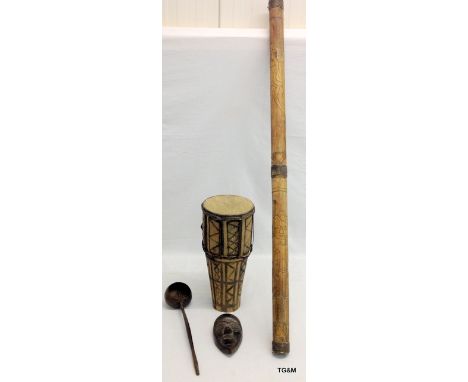 Four items of Tribal Art to include a bongo drum, a mask, a didgeridoo and a ladle