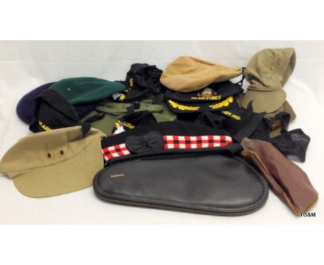 A quantity of military hats and a leather shooting and browning handgun case