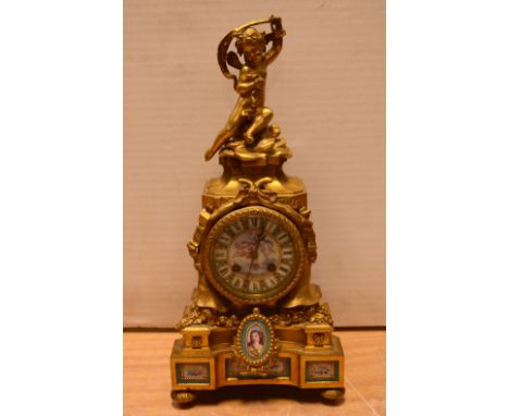 A late 19th century French gilt metal and porcelain mounted eight-day mantel clock, the painted enamel dial set with Roman nu