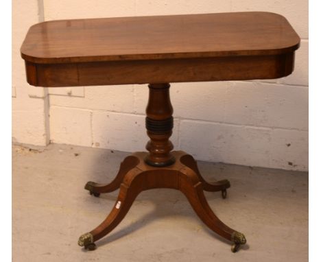 A 19th century mahogany oval sofa table on turned column support to quatrefoil base, brass feet terminating in castors.