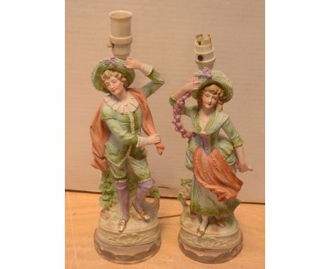 A brass three-branch electric table lamp and a pair of bisque figures, each later converted to table lamp bases (3).