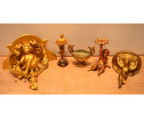 A carved wood gilt cherubic wall bracket, a plaster wall bracket, a candlestick of recumbent cherubic form, a soap dish of ch