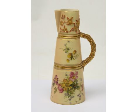 Royal Worcester; an ivory blush triple-tier jug, hand-painted with floral decoration and gilt-heightened, faux bamboo handle,