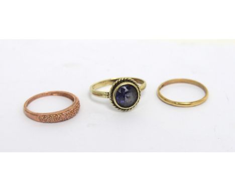 A 9ct white gold dress ring set with central circular amethyst stone, size Q, a yellow metal ring set with tiny stones, size 