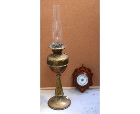 A late 19th century brass column oil lamp and a contemporary barometer (2).