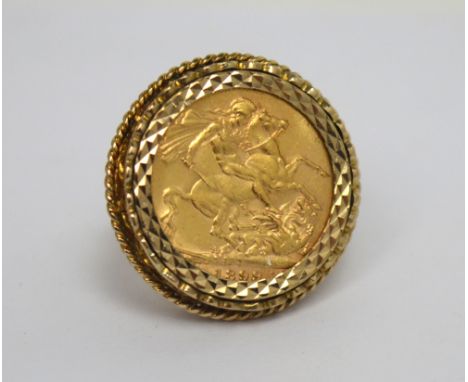 A Victorian full sovereign 1899, set as a ring in a scrolling and trellis 9ct gold mount, size N1/2, approx 14.6g.