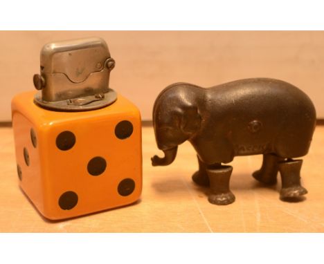 A 1960s die-form table lighter and a novelty Victorian walking cast metal elephant with articulated legs and trunk (2).