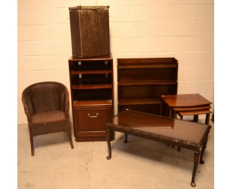 A mid-20th century mahogany waterfall-front bookcase with four shelves, height 93cm, a nest of three graduated flame mahogany