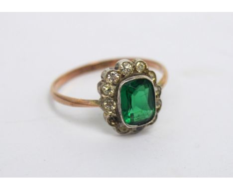 A 9ct gold dress ring with central emerald-cut green stone with small white stone surround, size Q, approx 2.5g.