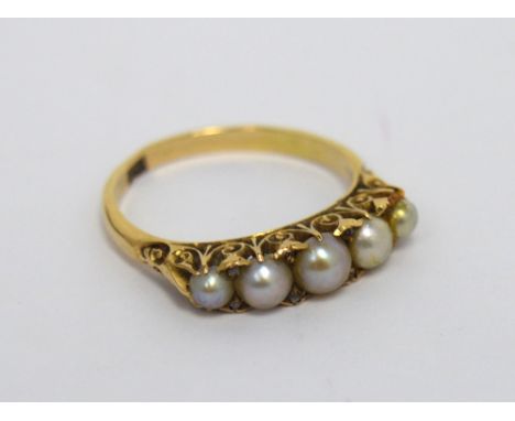 An Edwardian 9ct gold ring set with five graduated pearls and tiny diamond chips, inscribed to inner band 'Dad, 27-5-04', siz