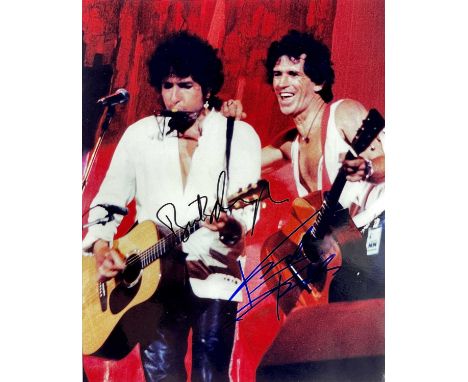 SIGNED - Bob Dylan and Keith Richards. A photograph of the two musicians performing together at Live Aid, 1985, signed in bla