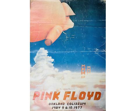 A 'Pink Floyd' concert poster designed by Randy Tuten. Showing an inflatable pink pig floating towards The Golden Gate Bridge