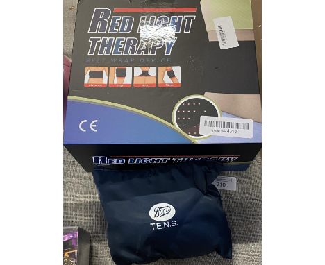 A boxed red light therapy belt wrap device and a tens machine (untested) 
