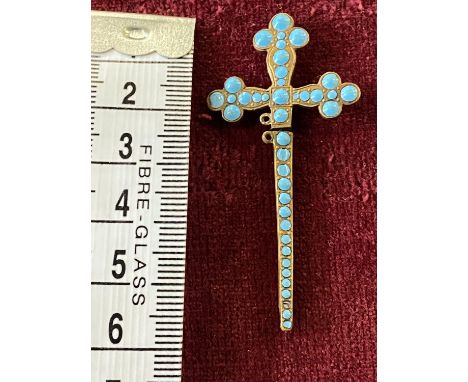 A stick pin in the form of a crucifix with turquoise decoration 