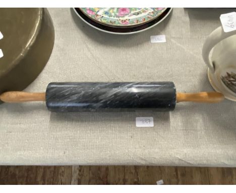 A vintage marble rolling pin with wooden handles 