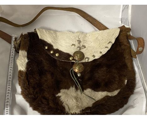 A vintage native Indian style hand sewn hunting shoulder bag made from animal hide 
