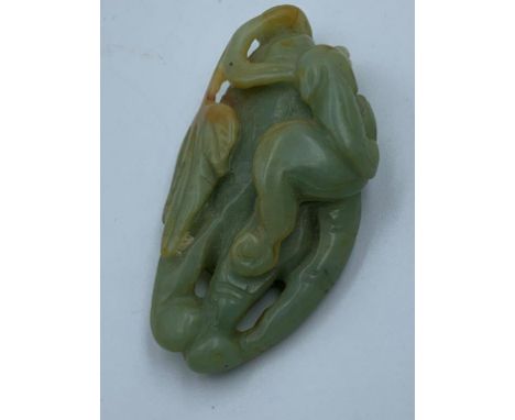 2 Carved Oriental jade pendants, one of a boy with lotus, the other of foliage 