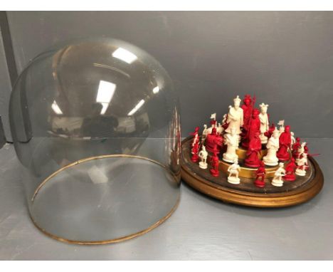 C19th Chinese carved ivory chess set in a glass domed display case 