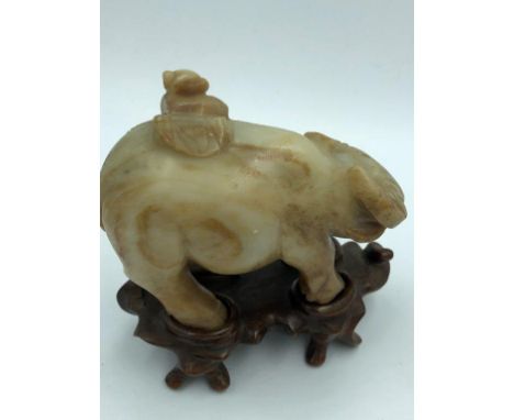 C18th/19th jade carving of a boy on buffalo, wood stand 11 cm H 