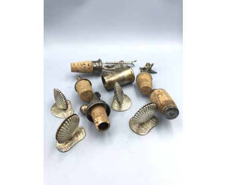 3 Sterling silver vesta cases, 1 with engine turned decoration, 4 Silver plated scallop shell menu holders &amp; 4 wine bottl