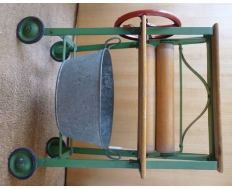 A vintage green and red painted steel and polished wooden Tri-ang toy mangle, on wheels with an attendant galvanised iron tub