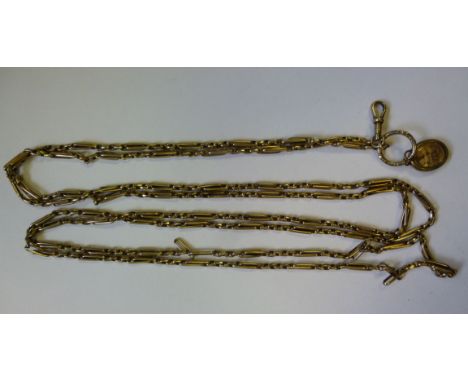 A gold coloured metal ring and rod link muff chain