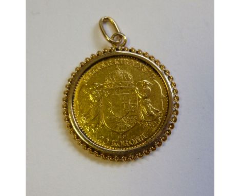 A Hungarian 20 Korona gold coin, set in a twist wire frame with a pendant ring