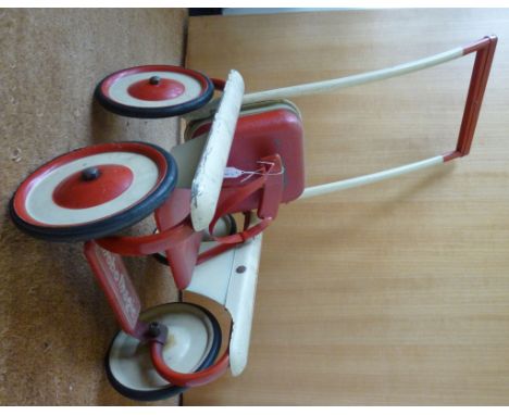 A vintage cream coloured and red painted steel Mobo Magic dolls' pushchair with a mechanically adjustable restraint 