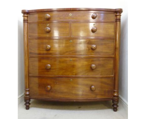 A late Victorian mahogany bow front dressing chest, having a frieze drawer, over two short/three graduated long drawers with 