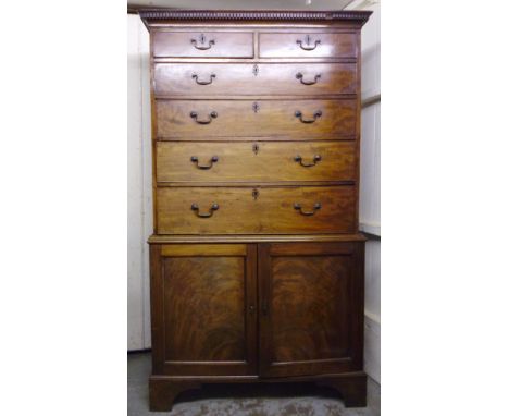 An early 19thC mahogany chest, having a dentil moulded cornice, over two short/three long and a secretaire drawer, enclosing 