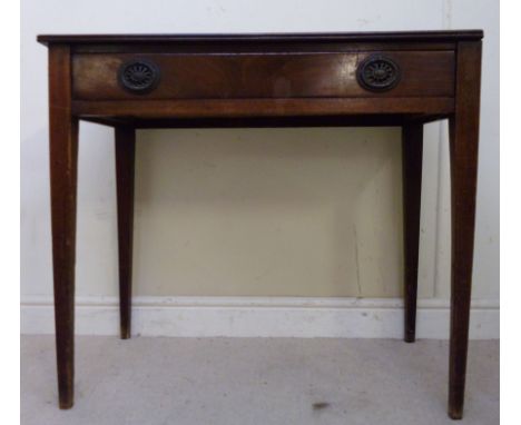 An early 19thC country made, figured mahogany side table, the top having a reeded edge, over a frieze drawer with cast brass 