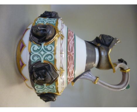 A Worcester Kerr & Binns porcelain 'helmet and heads' jug of squat, bulbous form, having a high loop handle, decorated in col