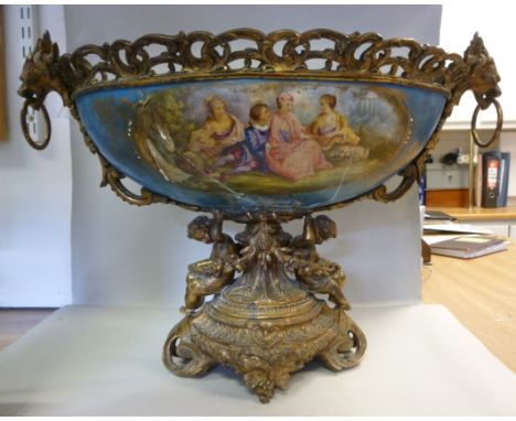 A late 19thC Continental porcelain and gilt metal centrepiece, the oval bowl decorated with figural vignettes and flora, set 