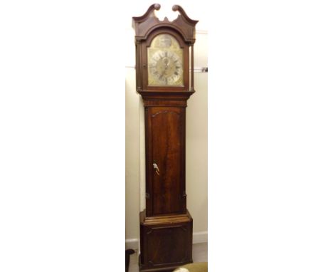 A George III mahogany longcase clock, having a swan neck pediment, over an arched door, flanked by reeded, quadrant flanks an