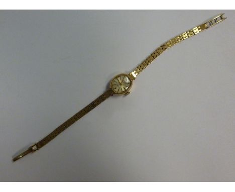 A lady's Rotary 9ct gold oval cased, bracelet wristwatch, faced by a baton dial 
