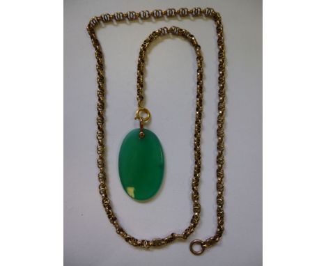 A yellow metal multi-ring link neckchain with an oval green tablet pendant 
