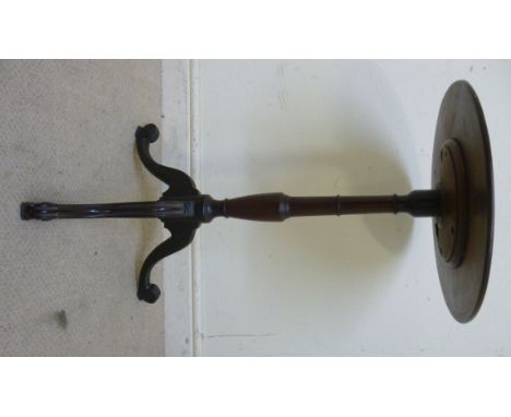 A mid 19thC mahogany pedestal table, the turned, figured top, over a vase and ring turned column, raised on a moulded and scr