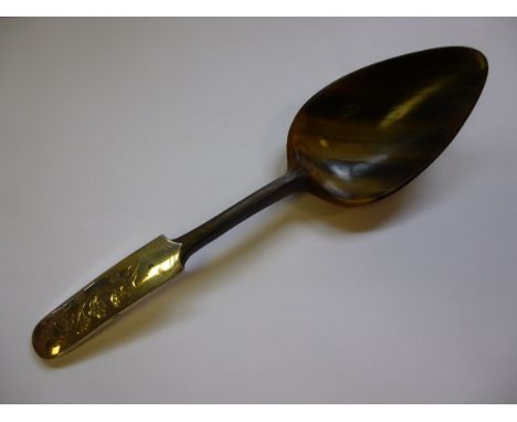 A Scandinavian moulded and carved horn spoon with an applied silver mounted and floral engraved stem