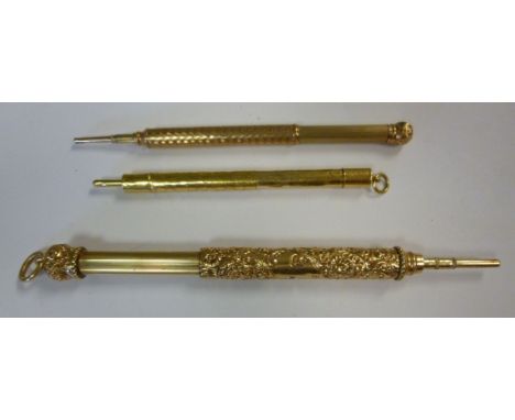Three early 20thC yellow metal propelling pencils, viz. one with engine turned decoration; another having engraved ornament; 