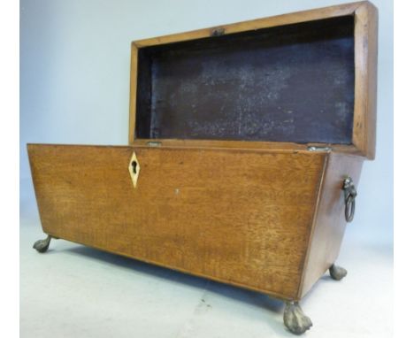 A late Regency satinwood string inlaid mahogany tea casket of sarcophagus form with opposing brass lion mask ring handles and