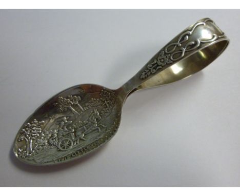 A baby's silver feeding spoon, the bowl cast and chased with a nursery rhyme scene and inscribed 'This Little Pig Went to Mar