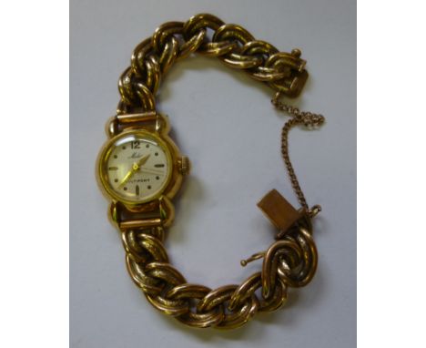 A lady's Mielo 18ct gold round cased wristwatch, faced by a baton dial, on a chased oval link bracelet
