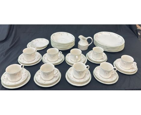 Royal Doulton Caprice pattern to include 9 cups and saucers, a milk jug, dinner plates and bowls