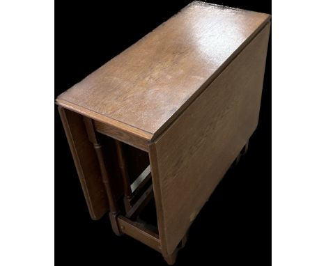 Heavy solid oak gate leg table measures approximately with leaf down 28 inches tall x 34 long and 15 deep