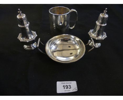 A mixed lot of hallmarked silver items comprising a pair of pepperettes, a christening beaker and a further circular two hand